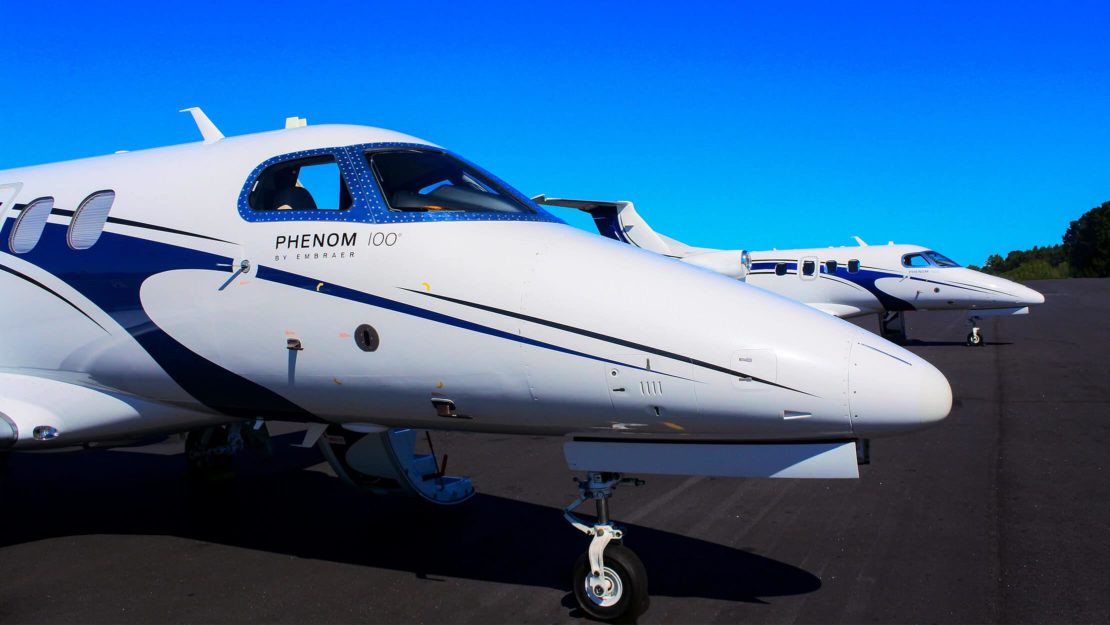 Two Phenom 100s on a runway